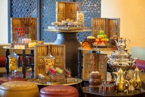 
a table filled with lots of different types of cakes at Oaks Ibn Battuta Gate Dubai in Dubai
