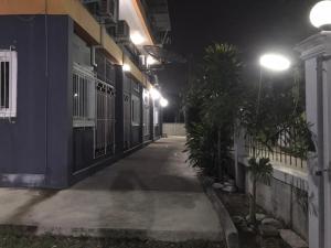 an empty alley at night with street lights at BIG BEN Residence in Kaeng Khoi