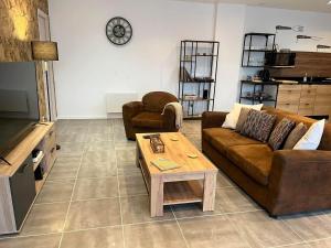 a living room with a couch and a coffee table at Bleu Horizon in Quiberville