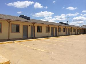 an empty parking lot in front of a building at Lake Shore Motel in Mannford