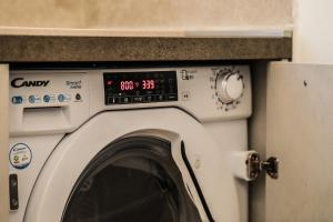 a washing machine with a digital clock on it at Romarina in Rome