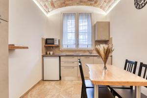 a kitchen with a wooden table and a dining room at Romarina in Rome