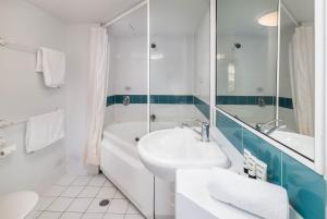 a bathroom with a sink and a tub and a toilet at 2BR 2Bath L8 Executive Apartment, in City Centre in Canberra