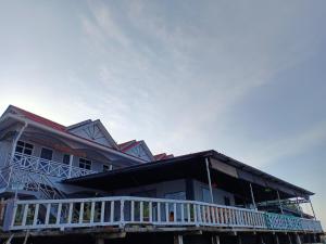 a house with a white balcony on the side of it at Suhaila Palace in Perhentian Islands