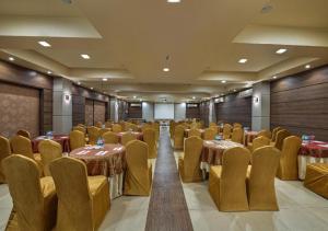 a banquet hall with tables and chairs in a room at Meritas Crystal Resort in Lonavala
