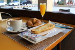 a breakfast of coffee and croissants and a glass of orange juice at Hostal San Isidro in Autol