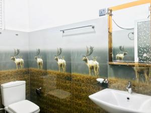 a bathroom with a mural of deer on the wall at Mountain Villa Adam's Peak in Adams Peak