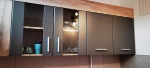 a kitchen cabinet with glass doors in a kitchen at Focus Lux in Miercurea-Ciuc