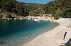 a beach with boats in a body of water at Rafa´s house in Selca