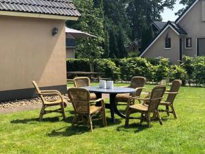 a table and chairs sitting in the grass at 't Sinnehûs in Sondel +37 photos