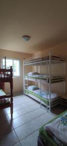 a room with three bunk beds in a room at Gite etape chez Paule et jo in La Possession