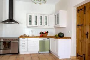 La cuisine est équipée de placards blancs et d'un réfrigérateur vert. dans l'établissement El Trujal de las Bardenas, à Cabanillas