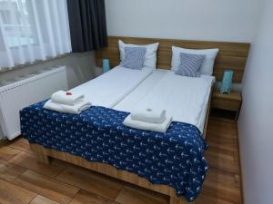 Posteľ alebo postele v izbe v ubytovaní Apartamenty Kapitanskie