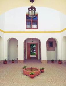 a large white building with a courtyard with a table at El Trujal de las Bardenas in Cabanillas