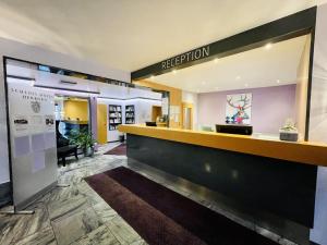 a reception area of a hotel lobby with a reception counter at Schloss Hotel Herborn in Herborn