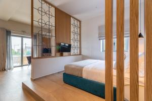 a bedroom with a bed and a tv in it at Linari Villas in Stoupa