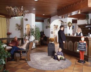 a group of people sitting in a waiting room at Isar Hotel in Freising