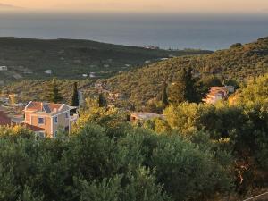 a town on a hill with the ocean in the background at Villa Thea - Τhe View 1st floor in Áno Yerakaríon