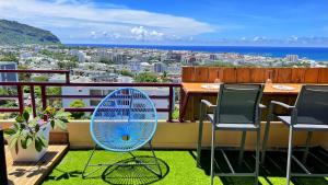 a blue fan sitting on top of a balcony at Sea View & More… in Saint-Denis