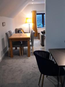 ein Wohnzimmer mit einem Holztisch und Stühlen in der Unterkunft Kettlesing Cottage, Harrogate in Harrogate
