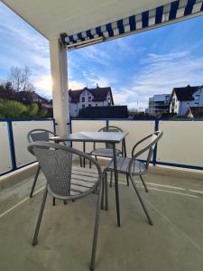 a table and two chairs on a balcony at HOME AWAY FROM HOME in Staad