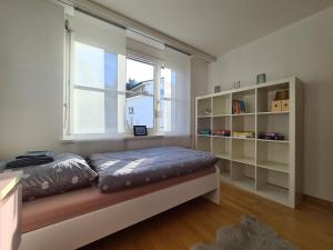 a bedroom with a bed in front of a window at HOME AWAY FROM HOME in Staad