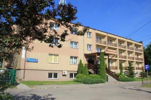 a large building with trees in front of it at Hotel Mława in Mława