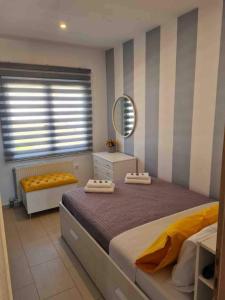 a bedroom with a large bed and a mirror at Colors Of The Sea in Leptokarya