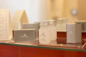 a shelf with two bottles of milk on a table at Regency Way Montevideo Hotel in Montevideo