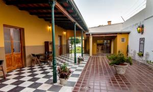 a courtyard of a building with potted plants at Solar del Río in Esquina