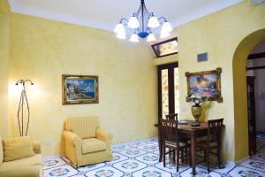 a living room with a chair and a table at Residence Marina Corta in Lipari