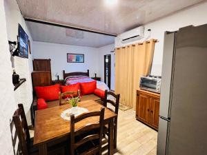 a kitchen and dining room with a table and a couch at Monoambiente en Durazno in Durazno