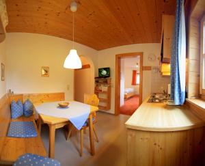 a kitchen and living room with a table and chairs at Haus Maroi in Stuben am Arlberg