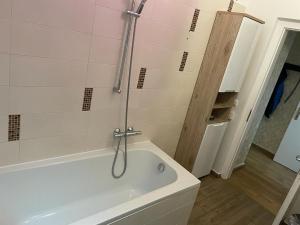 a bathroom with a white tub and a shower at Ferienwohnung M&M in Herford