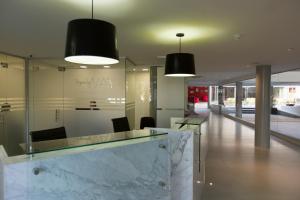 a lobby with two black lights and a marble counter at Regency Way Montevideo Hotel in Montevideo