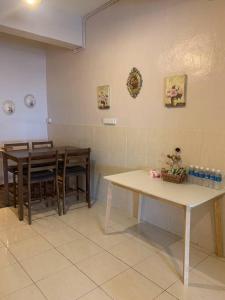 a kitchen with two tables and chairs and a table at 4-6人家庭 Cozy Home @ Kutoba Square in Tawau