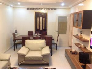 a living room with a table and a chair at JOLI APPARTEMENT A DAKAR,ESPACES MAMELLE in Dakar