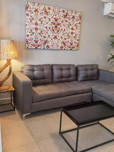 a living room with a couch and a painting on the wall at Casa Buba in Cozumel