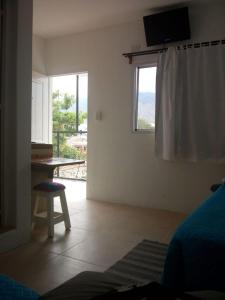 a bedroom with a desk and a window with a table at Divina Presencia in Cafayate