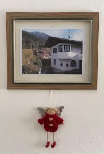 a stuffed animal hanging on a wall with a picture at Haus Spatzl in Garmisch-Partenkirchen