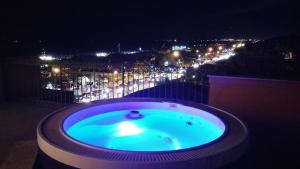 a large swimming pool with a fountain and lights at Arianna Hotel in Marina di Pietrasanta