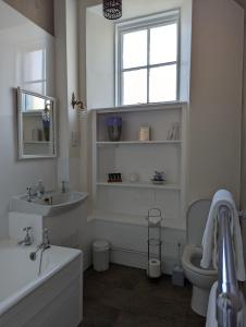 a bathroom with a sink and a tub and a toilet at Furain in Peterculter