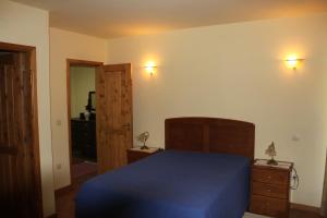a bedroom with a blue bed and a closet at Casas do Corvo in Ventosa +55 photos