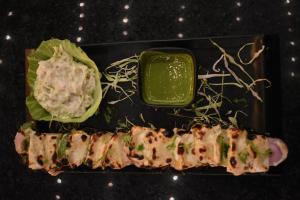 a plate of food with lettuce and a green sauce at Hotel The Balam in Jodhpur