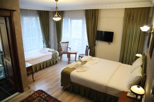 Postel nebo postele na pokoji v ubytování Basileus Hotel