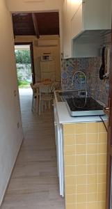 a kitchen with a sink and a counter top at Casa Perla Rei - 50 meters from the beach in Costa Rei +52 photos