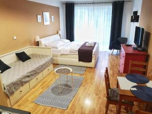 a bedroom with a bed and a table and chairs at Apartmány Margo Sun in Martinske Hole