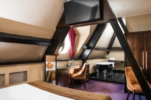 a room with a bed and a tv on the ceiling at Great Victoria Hotel in Bradford