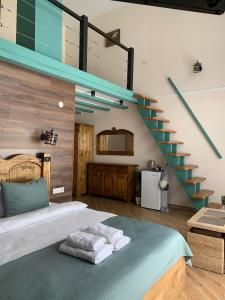 a bedroom with a bed with a staircase in it at Gostynets in Yaremche