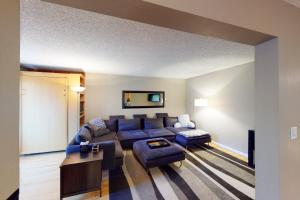 a living room with a blue couch and a table at Gore Creek Getaway in Vail +41 photos
